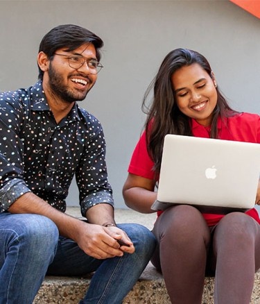 Boy girl sitting with laptop
