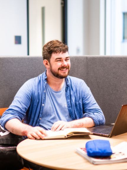Male student sitting and smiling
