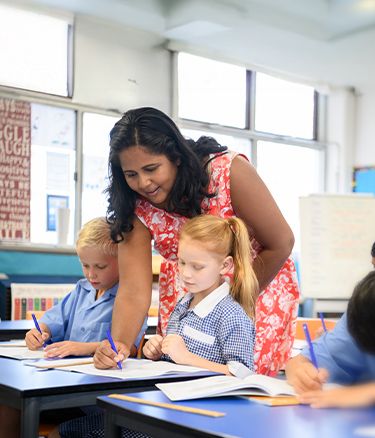 Teacher writing in the student's notebook