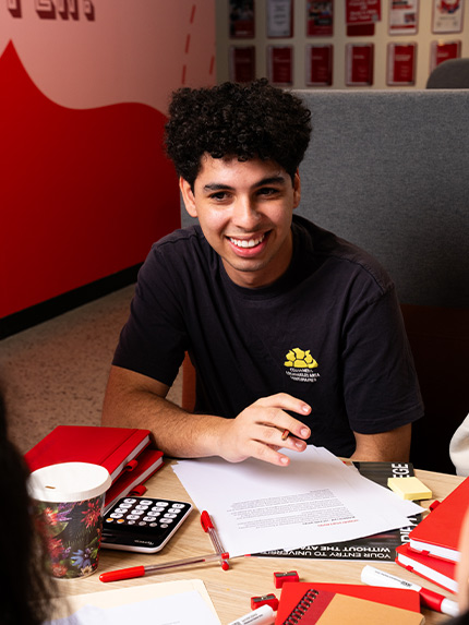 Male student sitting and talking with other students