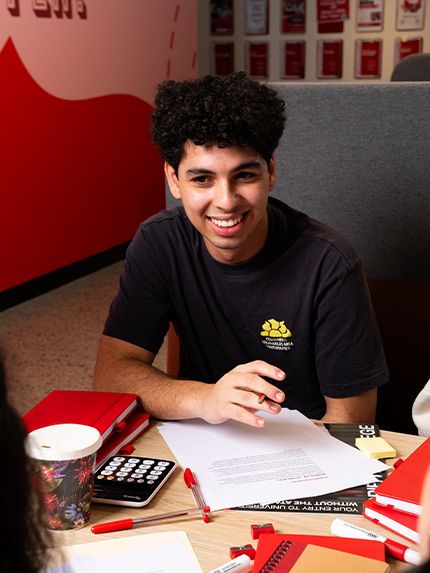 Male student sitting and talking with other students