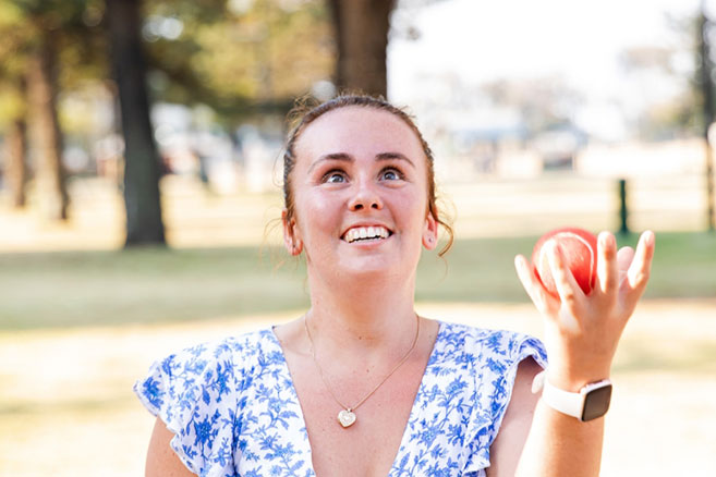 Female student juggling outside