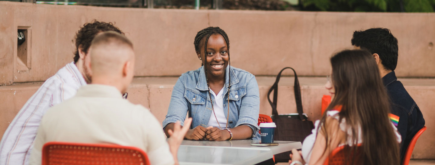 Female student sitting group outside
