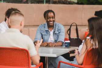 Female student sitting group outside