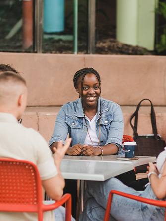 Female student sitting group outside
