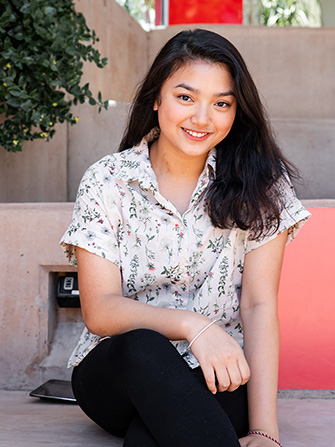 Female student sitting stairs campus