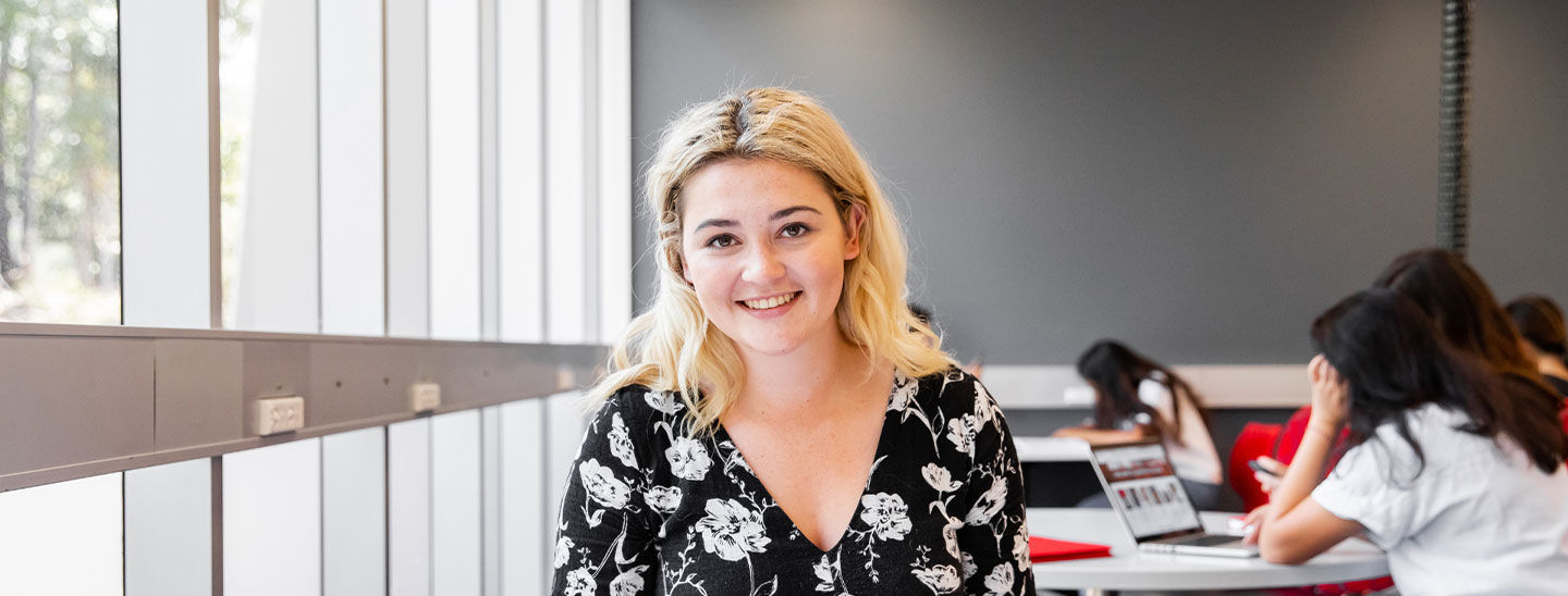 Female student smiling in classroom