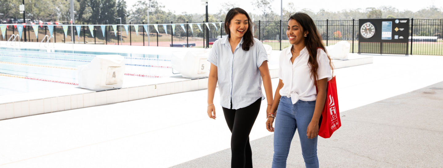 Female students walking sport pool facilities