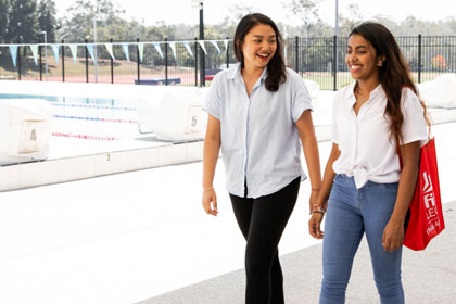 Female students walking sport pool facilities