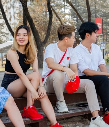 Five students sitting in college garden