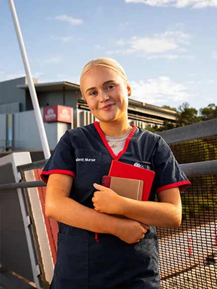 Student nurse smiling and standing outside