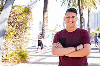 Male student outside happy