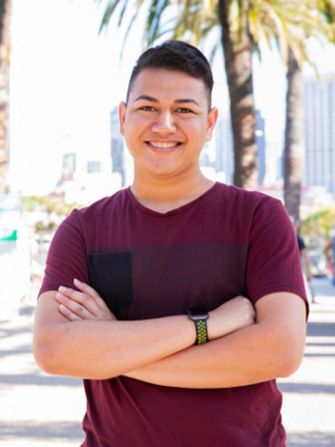 Male student outside happy