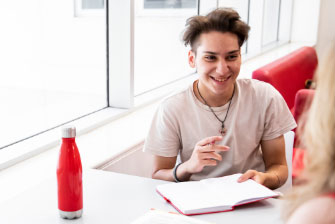 Male student school leaver teacher talking notes