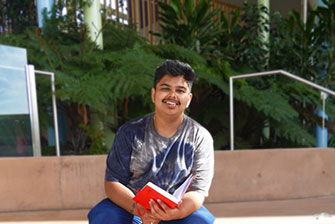 Male student sitting outside