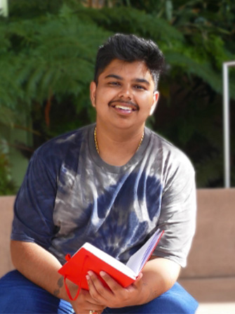 Male student sitting outside