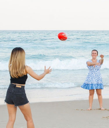 Students playing at beach