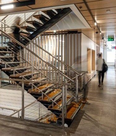 Modern staircase with a person walking nearby