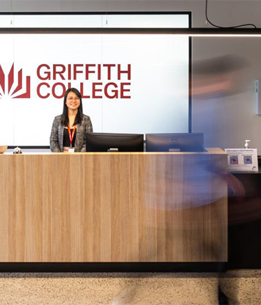 Female sitting in campus reception area