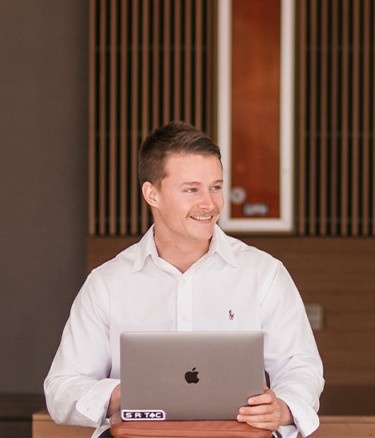 Single boy sitting with laptop