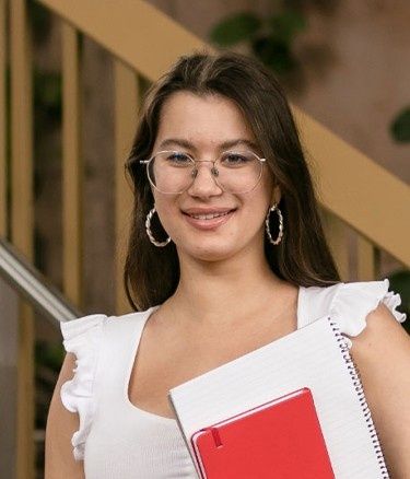 Single girl with notebook near stairs