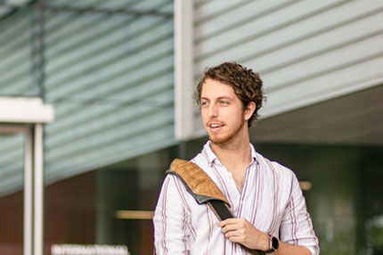 Student happy standing outside