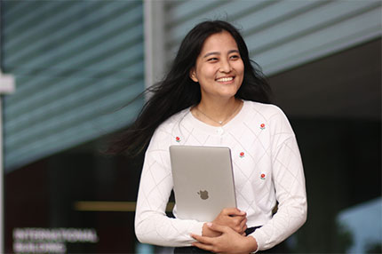 Student holding laptop