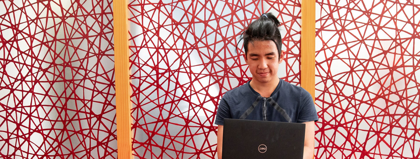 Student inside sitting working