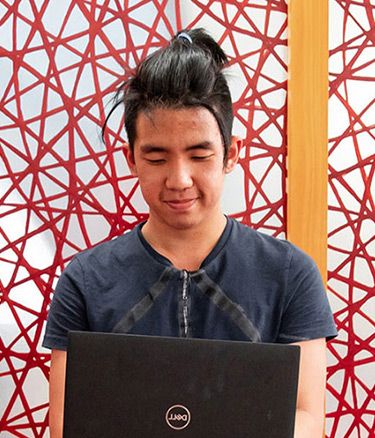 Student inside sitting working