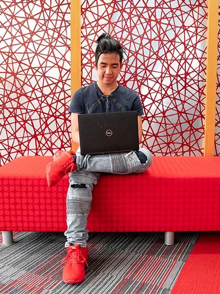 Student inside sitting working