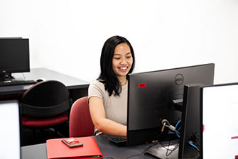 Student inside studying working computer