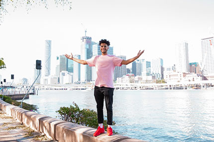 Student outside Brisbane happy standing