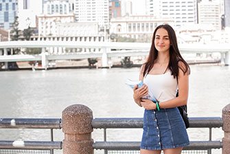 Student outside brisbane river