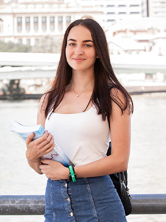 Student outside Brisbane river