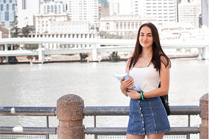 Student outside Brisbane river