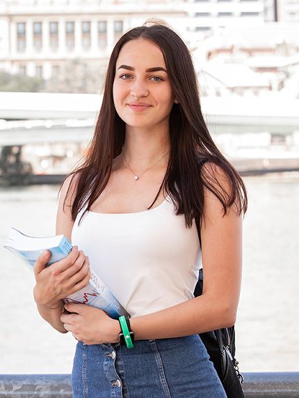 Student outside Brisbane river
