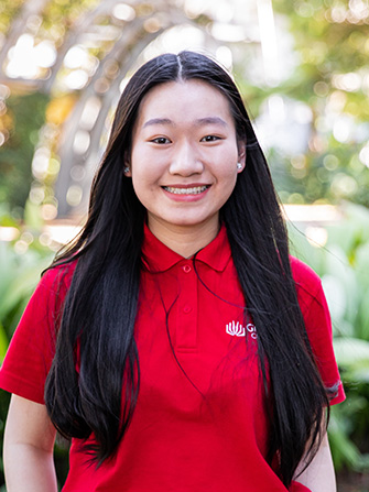 Student outside happy sunny