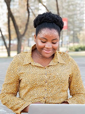 Student outside working studying