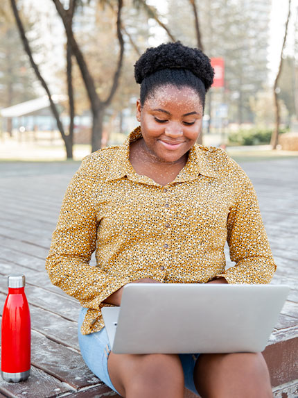 Student outside working studying