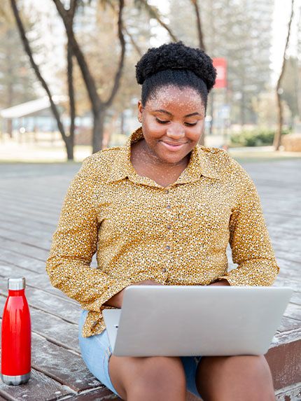 Student outside working studying