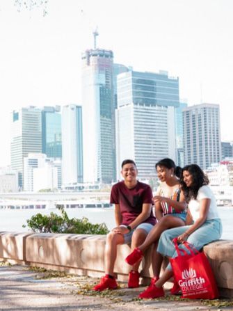 Students sitting roadside in Brisbane city