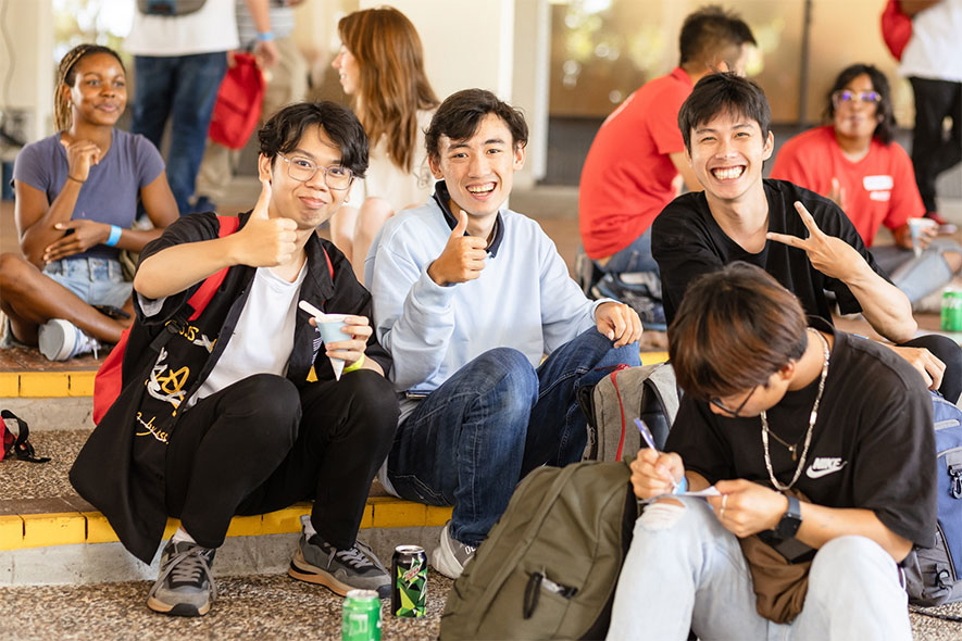 Students group sitting outside