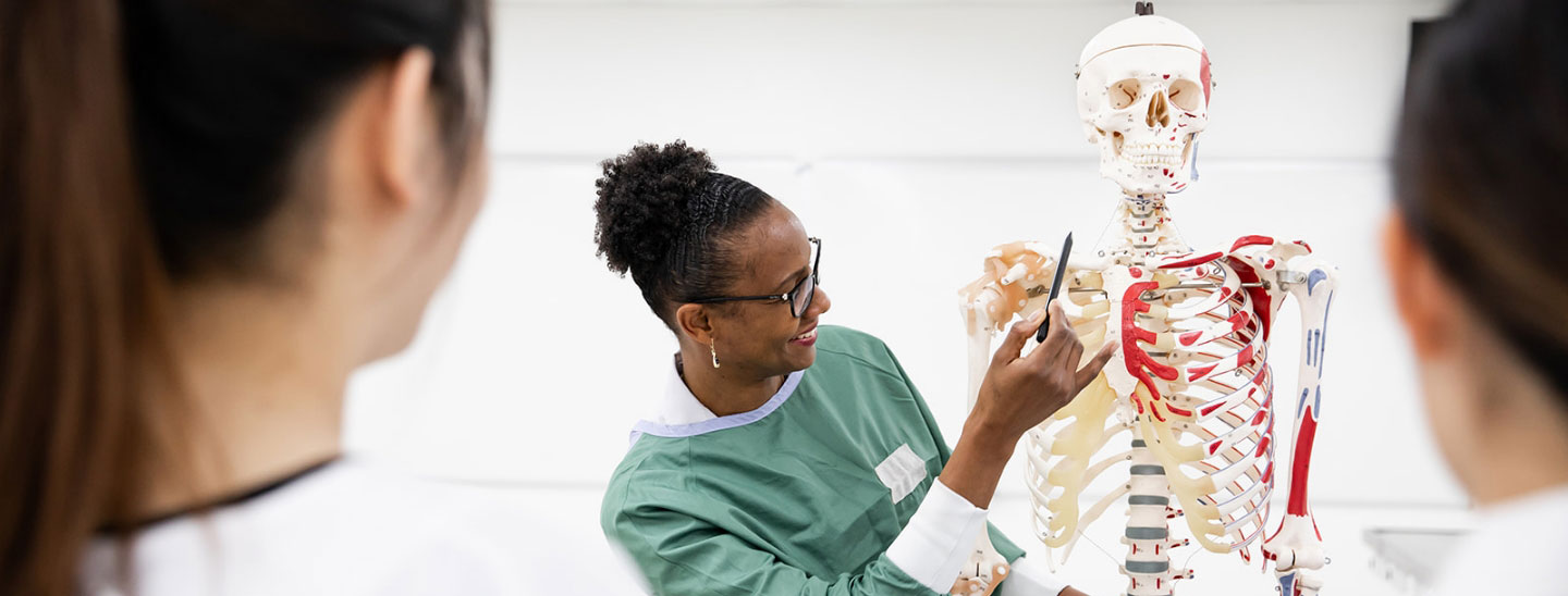 Students inside health lab human skeleton