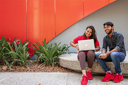 Students inside working studying on laptop