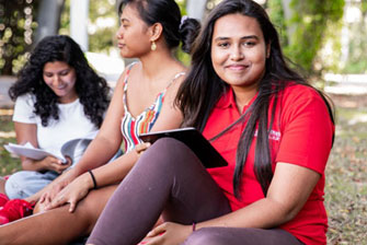 Students outside happy studying