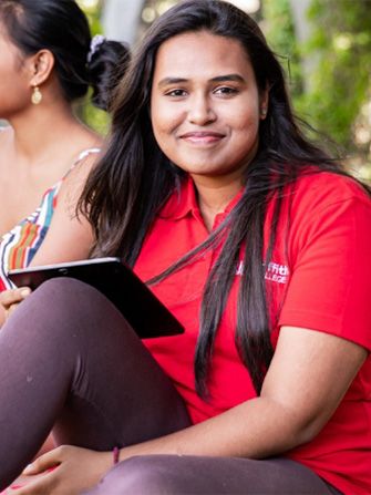 Students outside happy studying