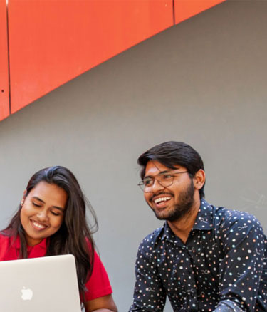 Students outside studying together happy