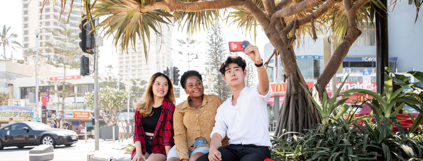 Students outside taking selfies