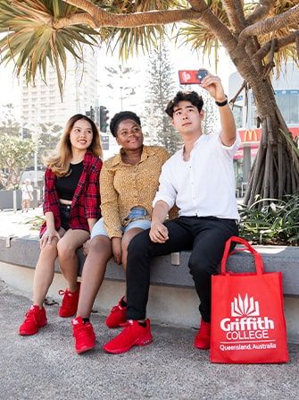 Students outside taking selfies