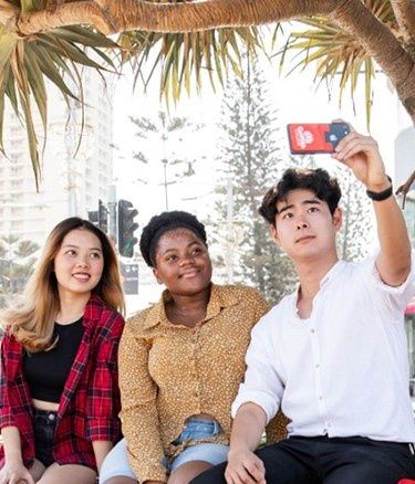 Students outside taking selfies